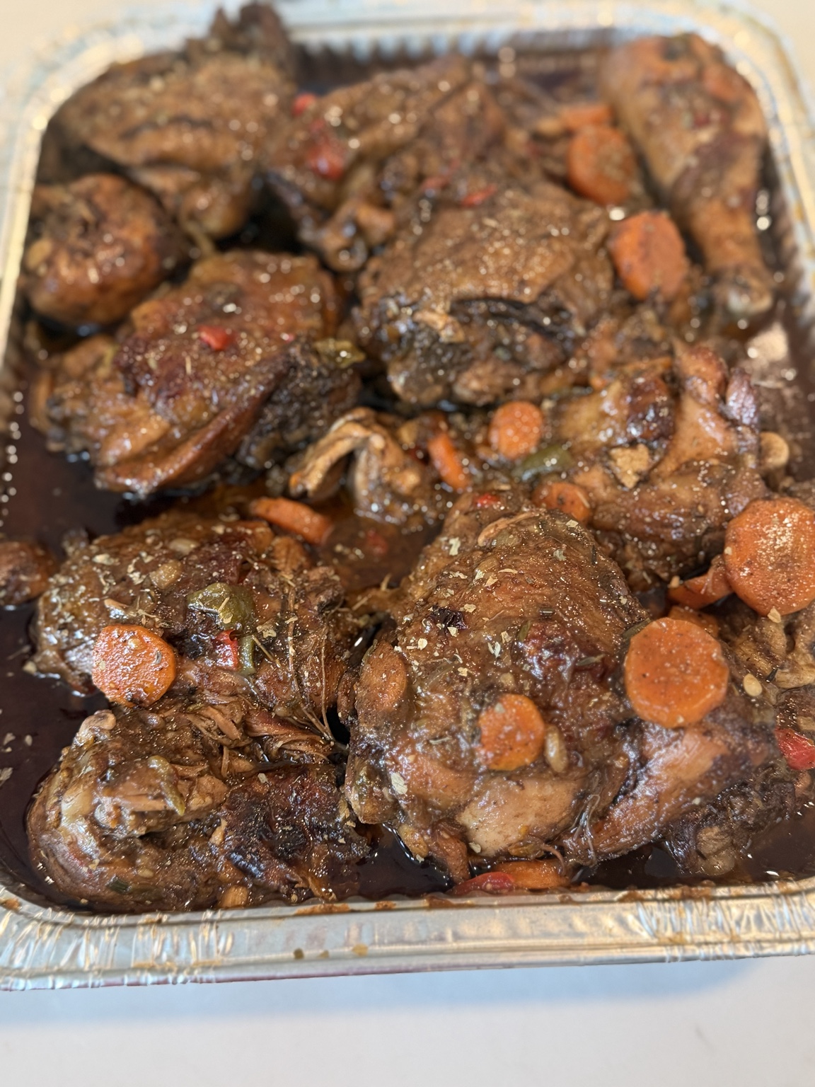 Brown stew chicken with carrots in a tray